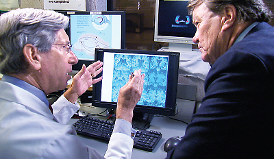 Photo: APA President Jeffrey Lieberman, M.D., explains brain images of people with schizophrenia to reporter Steve Kroft.