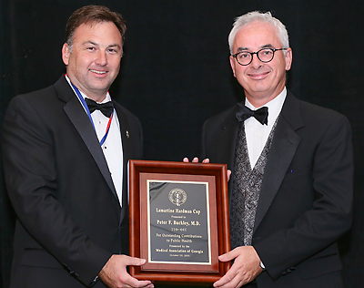 Photo of award presentation to Peter Buckley, M.D.