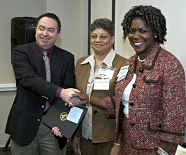 Photo: APA’s Annelle Primm, M.D., and Marilyn King receive an award.
