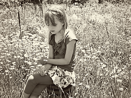 Photo of little girl sitting in grass