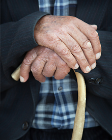 Photo: Older hands touching cane
