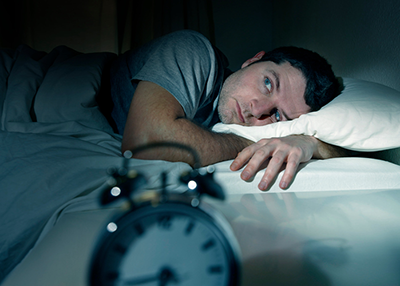 Photo: Man lying awake at nighttime