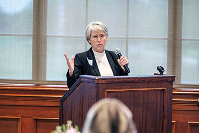 Photo of Kathleen Crapanzano, M.D., M.A.C.M. speaking at podium