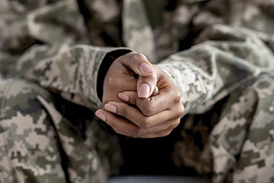 Photo of a soldiers clasped hands.