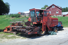 The farm uses modern equipment, such as this combine harvester. It reaps, threshes, and cleans grain crops.Photo: A combine used on Gould Farm
