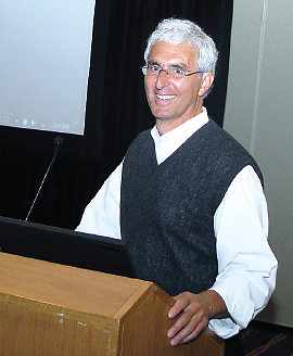 Photo: Howard Goldman speaking from the conference podium.