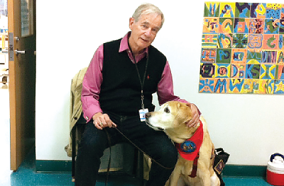 Irvin Jennings with Mikey the Therapy Dog at Reed Intermediate School in Newtown