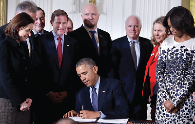 Photo: President Barack Obama signs the Clay Hunt Suicide Prevention for American Veterans Act in February 2015.