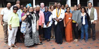 Photo: Sam O. Okpaku, M.D., Ph.D. (with a marigold garland), is photographed with other participants of the BPA’s meeting in New Delhi last November. Among them are Patricia Newton, M.D. (in black and white dress), BPA’s CEO and medical director; and Altha Stewart, M.D. (in pink jacket), then president-elect of APA.