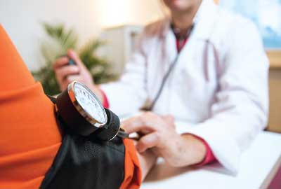 Photo: doctor taking blood pressure