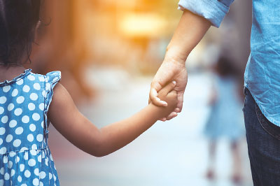 Photo: Parent and child holding hands