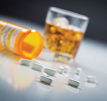 Photo: glass of alcohol and pills