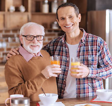 Photo: Gentleman and elderly and holding glasses together