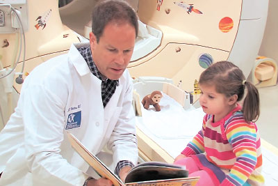 Photo: Doctor reading to a young child