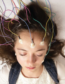 Photo: Young lady getting an Electroencephalography (EEG)