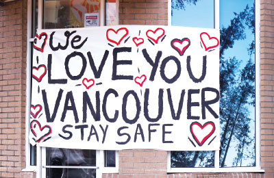 Photo: windows cover by a banner saying: "We love you Vancouver stay safe"