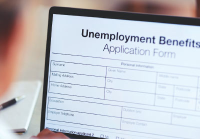 Photo: laptop screen showing an unemployment benefit application form.
