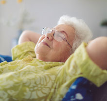 Photo: elderly relaxing on a armchair