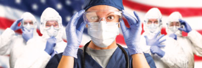 Photo: healthcare workers with PPE with a USA flag in the background