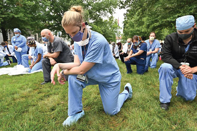 Photo: Emory health care staff take a knee in memory of George Floyd