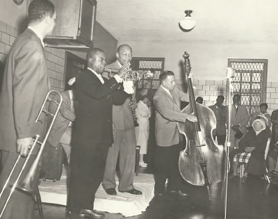 Photo: Louis Armstrong with his band playing