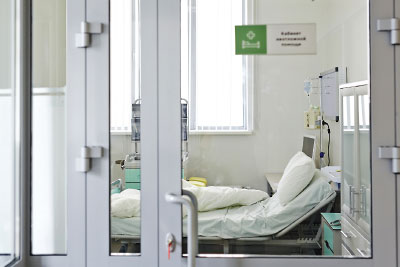 Photo: hospital bed behind close doors