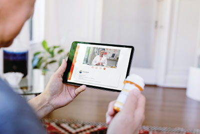 Photo: patient consulting a doctor through a tablet