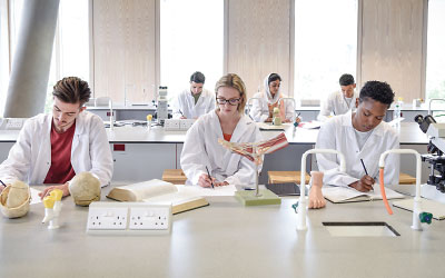 Photo: Students taking notes in a class lab.
