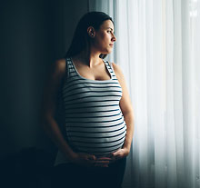 Photo: pregnant woman holding her belly