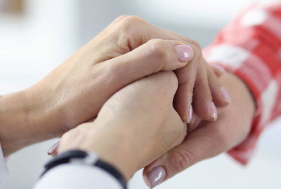 Photo: Dr. holding hand of a patient