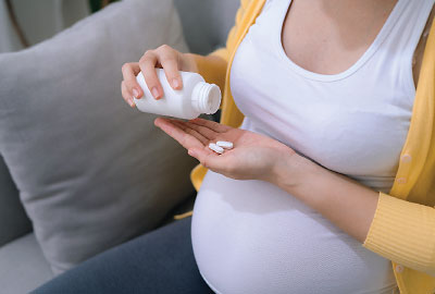 Photo: pregnant woman taking pills