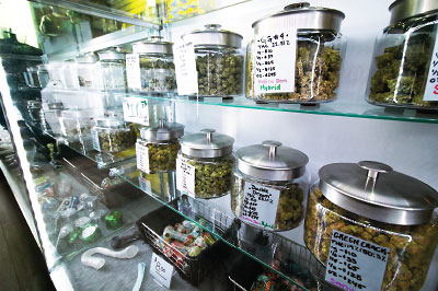 Photo: interior of a store showing shelves of cannabis jars and other marijuana paraphernalia