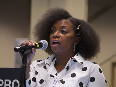 Photo of Dionne Hart, M.D., testifying at microphone.