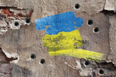 Photo: Ukrainian colors over a bullet ridden wall