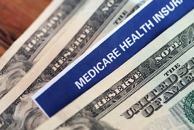 Photo: Dollar bills and Medicare Health Insurance document