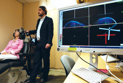 Photo: Nolan Williams, M.D., demonstrates the use of intermittent theta-burst stimulation following the Stanford Accelerated Intelligent Neuromodulation Therapy protocol.