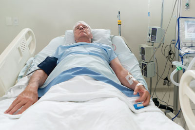 Person lying in a hospital bed
