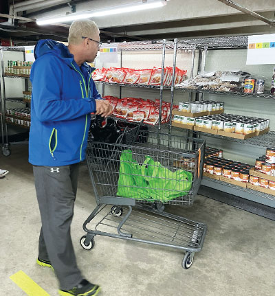 A volunteer with Jewish Family Services in Denver checks the stock in the organization’s food pantry.