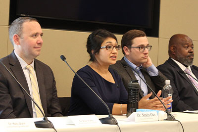 Smita Das, M.D., Ph.D., M.P.H. speaks at a table during a Congressional briefing. 