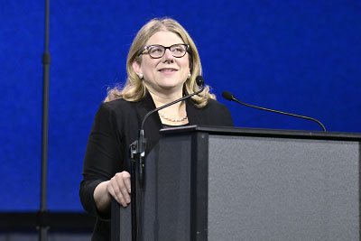 Photo: APA President Rebecca Brendel, M.D., J.D., speaking from the conference podium.