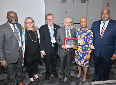 Gathering for a photo after the presentation of APA's Chester M. Pierce Human Rights Award to Ezra Griffith, M.D. (holding plaque), are (from left) Charles Dike, M.D., M.P.H., Rebecca Brendel, M.D., J.D., Saul Levin, M.D., M.P.A., Cynthia Turner-Graham, M.D., and Rawle Andrews Jr., Esq.