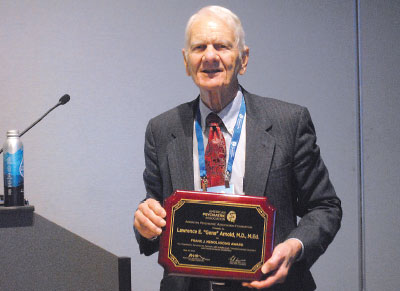 L. Eugene Arnold, M.D., recognized by APA for his long research into both conventional and complementary treatments for autism, displays his 2023 Frank J. Menolascino Award.