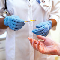 Close Up Shot Of Healthcare Workers Gloved Hands Holding Blister Pack Of Medication