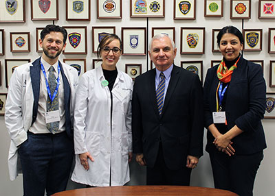 Photo: Joshua Wortzel, M.D., Camila Cosmo, M.D., Ph.D., Sen. Jack Reed (D-R.I.), and Tanuja Gandhi, M.D., pose for a photo.