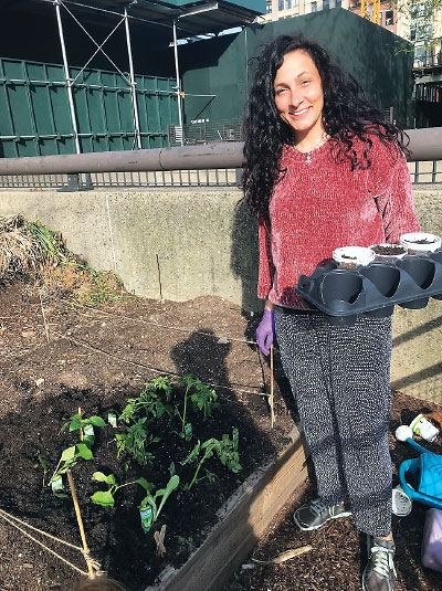 Argelinda Baroni, M.D., works in the urban vegetable garden she shares with her neighbors. Baroni is especially interested in the impact that climate change has on mental health, as green spaces increasingly disappear.