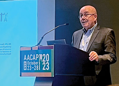 Photo of Victor Fornari, M.D. speaking at a podium.