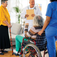 doctor talking with wheelchair patient and nurse