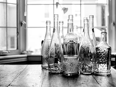 Photo of empty bottles on a bar.