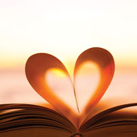 image of an open book with pages curled up to make the shape of a heart