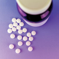 Image of pills laying scattered beside a pill bottle